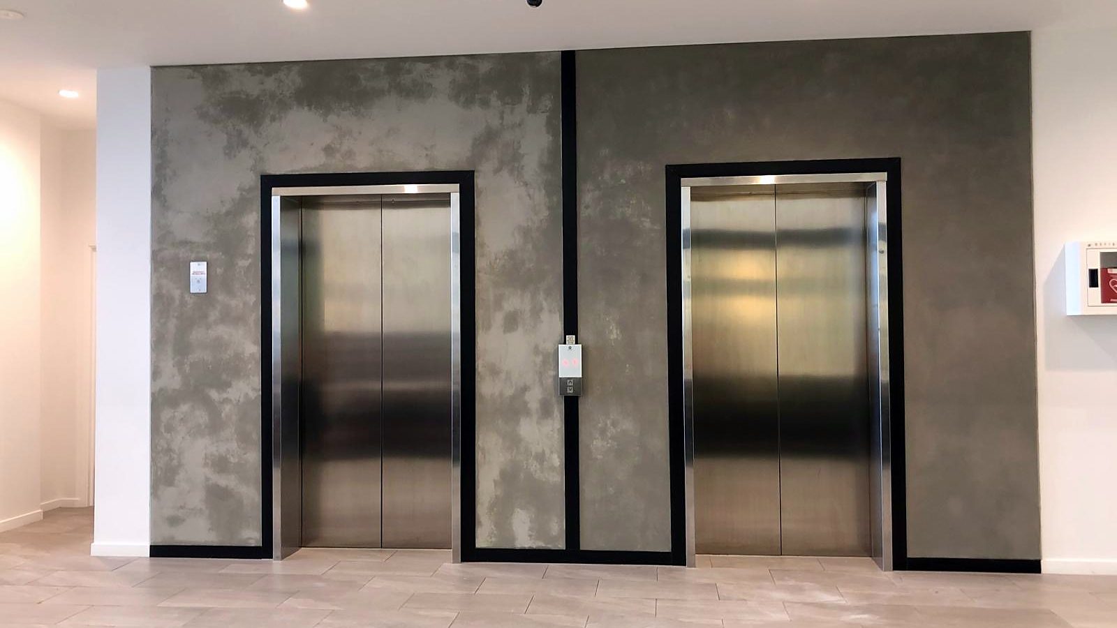 Concrete-look feature wall in a CBD lift lobby
