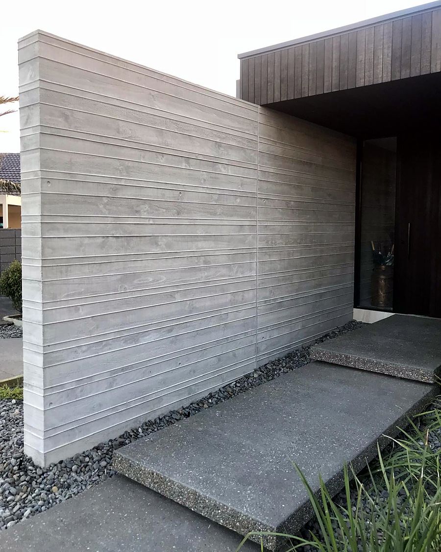 Board-formed concrete entry wall with stepping stones