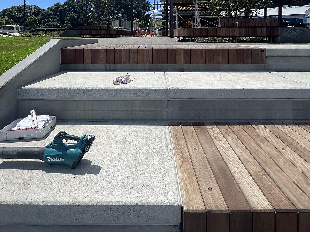 Finished concrete steps beside timber seating